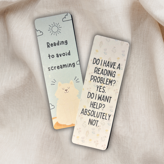 Double-sided laminated bookmarks printed on cardstock featuring humorous reading quotes — 'Reading to avoid screaming' with a cute cat illustration, and 'Do I have a reading problem? Yes. Do I want help? Absolutely not.' Ideal for book lovers and readers.